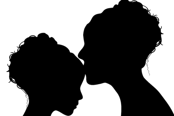 silhouette of mother kissing her daughter
